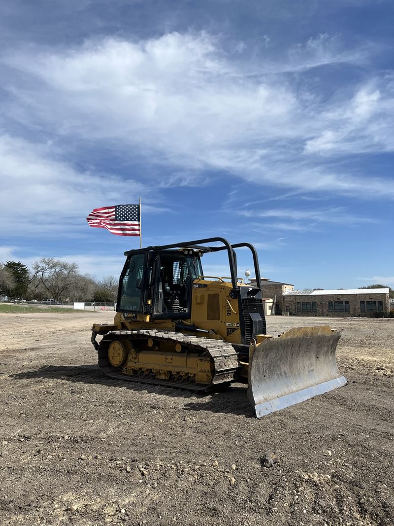 Dozer flying an American flag on a job site